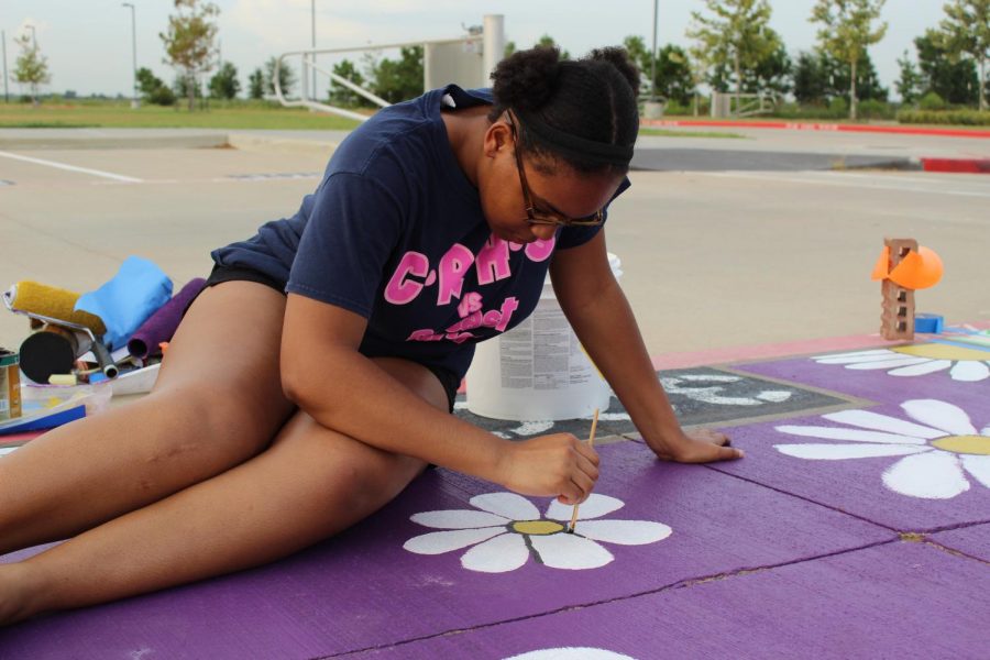 Senior Cassidy Howard paints her spot. 