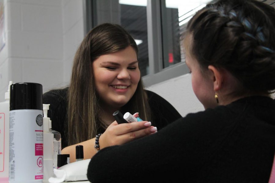 Lois Hill works on her nail art in class. 