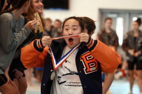 Junior Aldercy Bui shows her second place medal to her team.