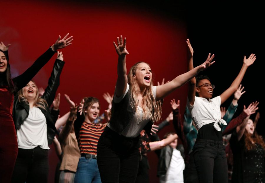 Junior Abbie Benton leads the choir in the closing group number which was a mashup of popular songs through the decades.