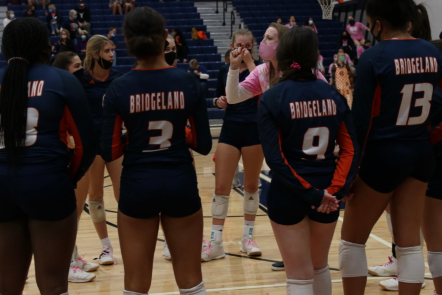 Coach Khalil talks to varsity volleyball during timeout in homecoming game on October 30 against Cypress Ranch.