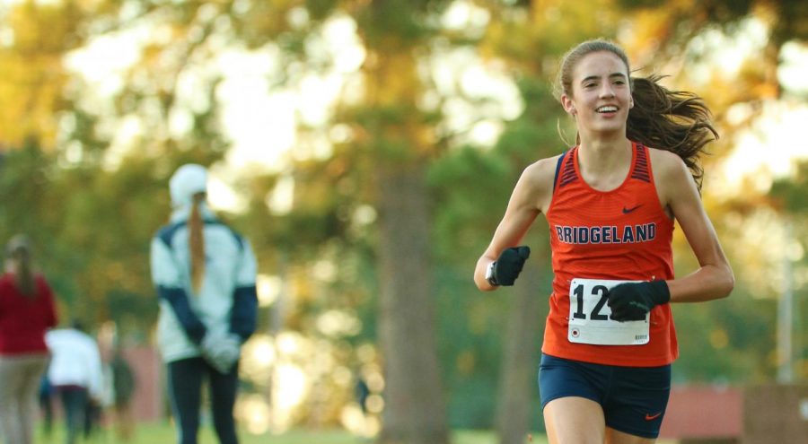 Sophomore Emily Ellis runs toward victory in the district varsity cross country meet. 