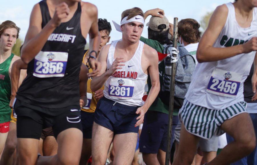 Past the first mile in, senior Randy Smith pushes up the hill to place ninth in state. 