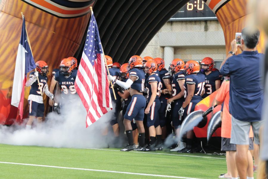 The Bears run out on the field at the beginning of the game.