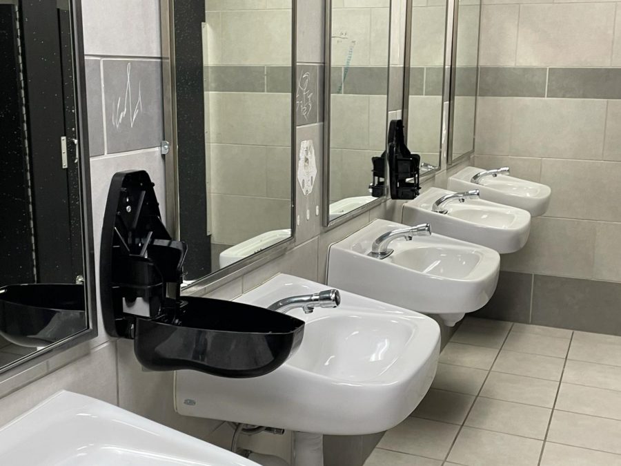 Empty soap dispensers in the boys bathroom