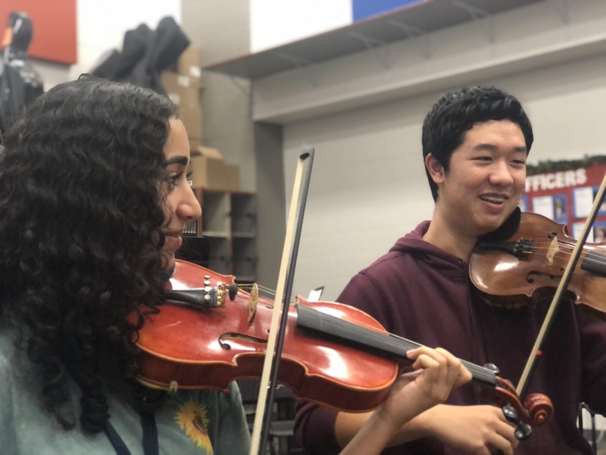 Juniors Naiya Rodrigues and Henry Zhang practice their music for Midwest.